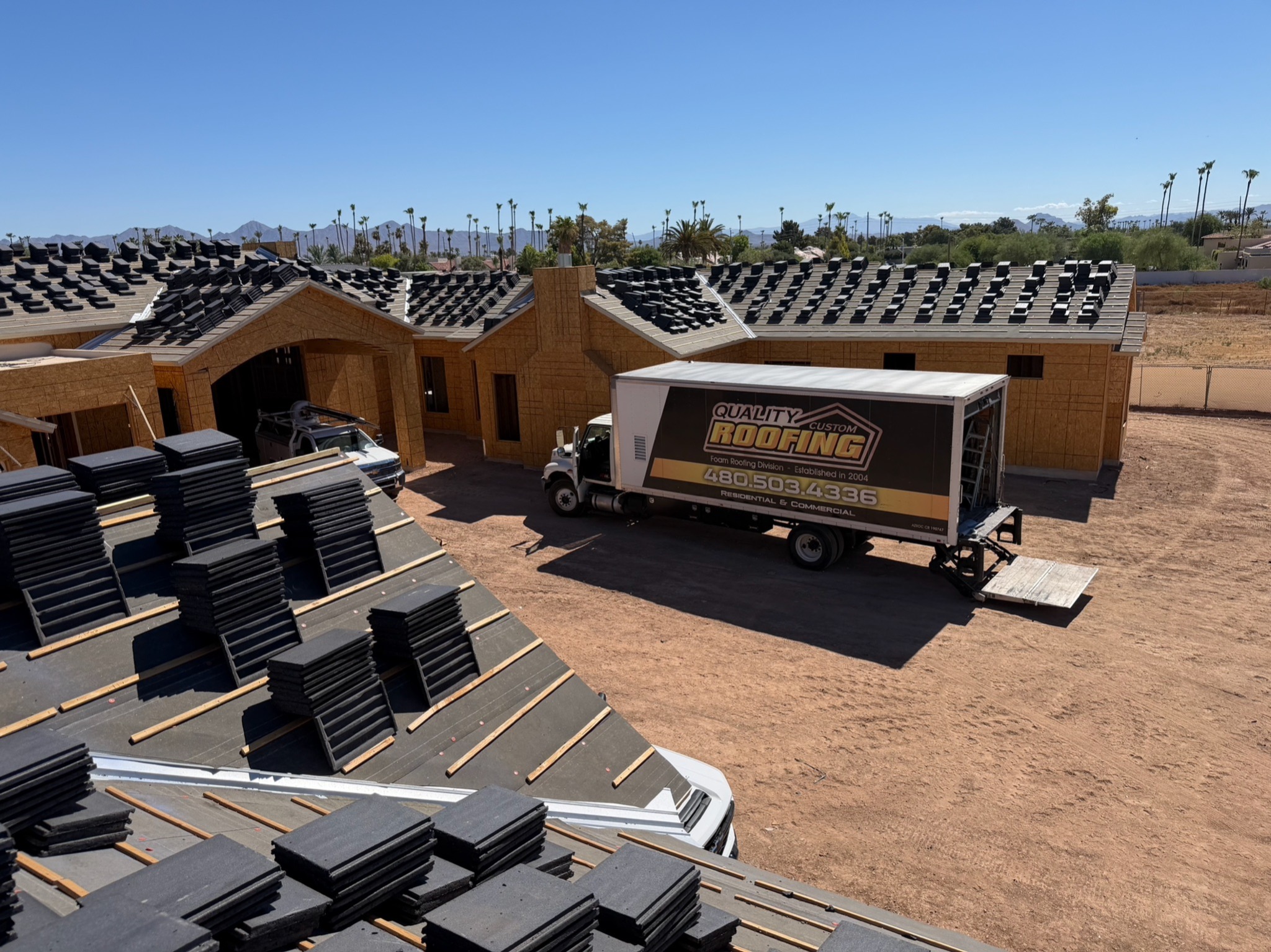 Quality Custom Roofing truck at Arizona new construction roofing project