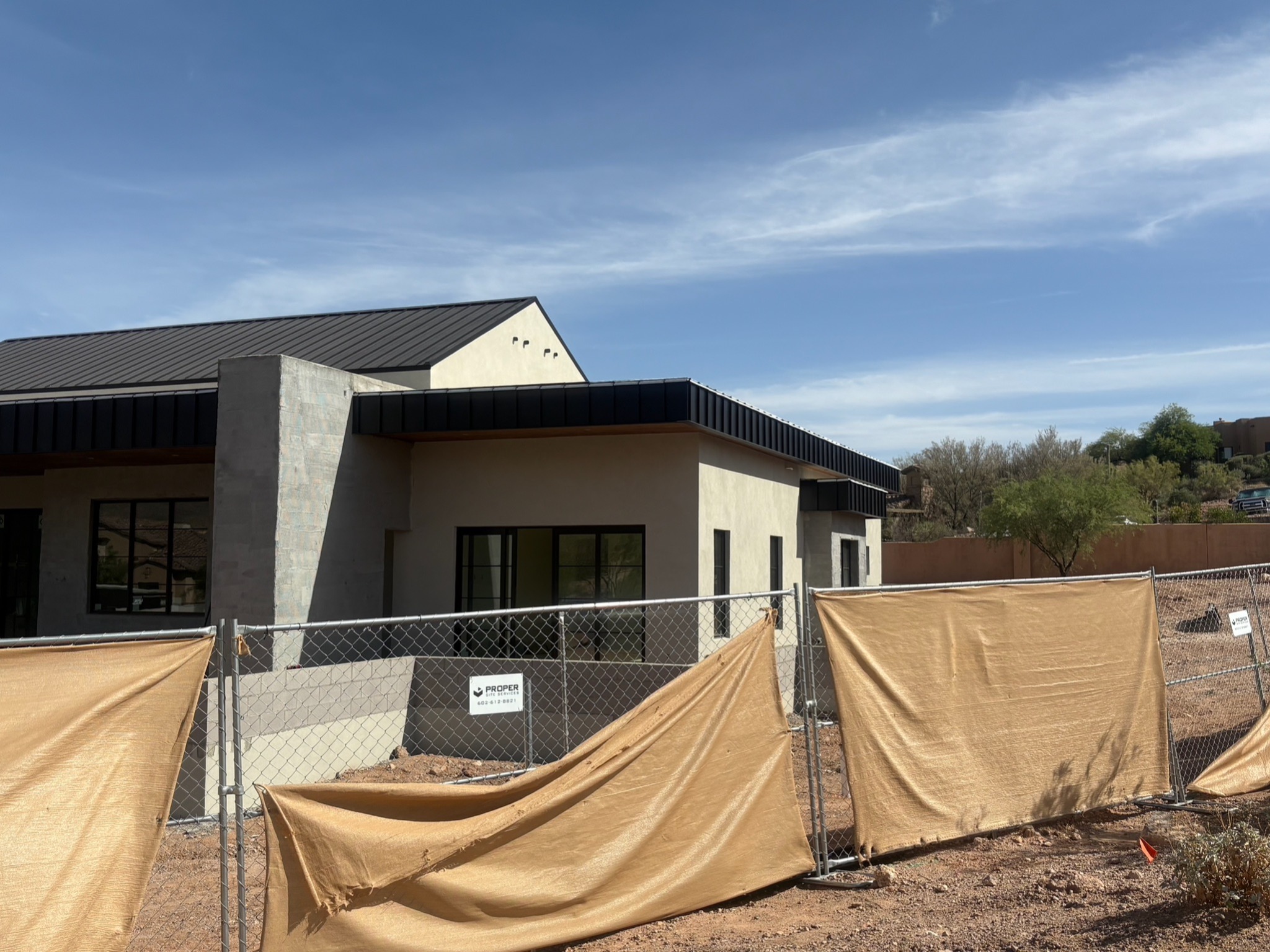 Standing seam metal roof installation with Arizona mountains